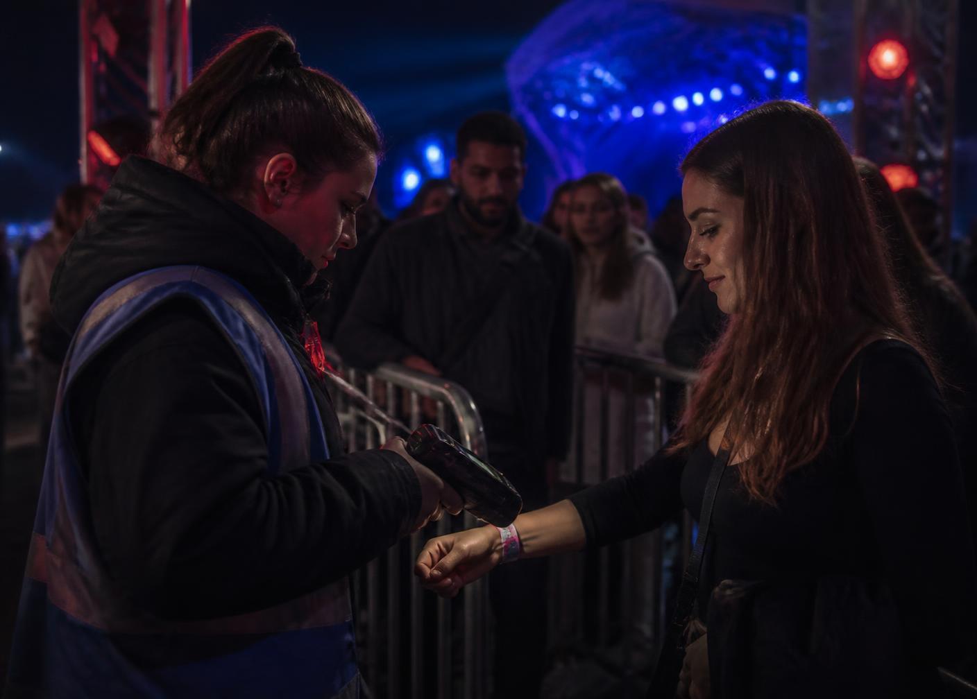 Credential being scanned at an event access checkpoint